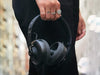 A photo of Nura Headphones held by a man showing close up the size of the headphones