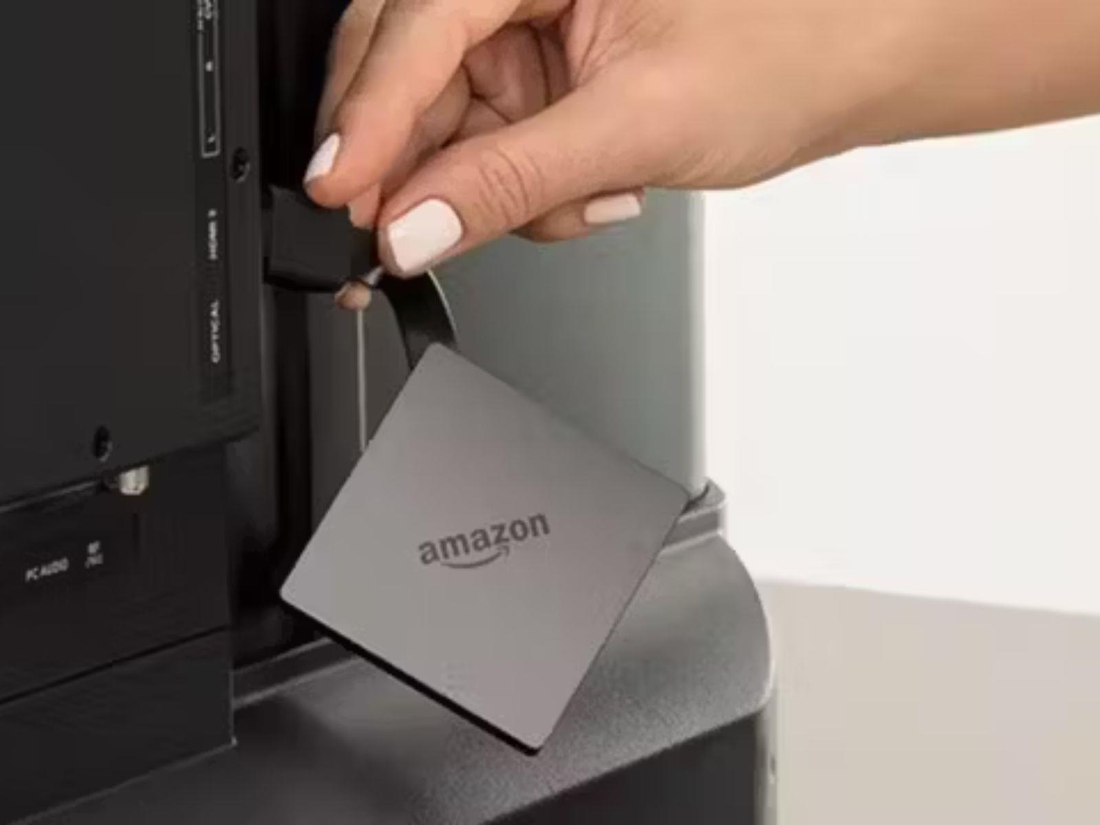 Amazon Fire TV Pendant Being Plugged Into a Tv