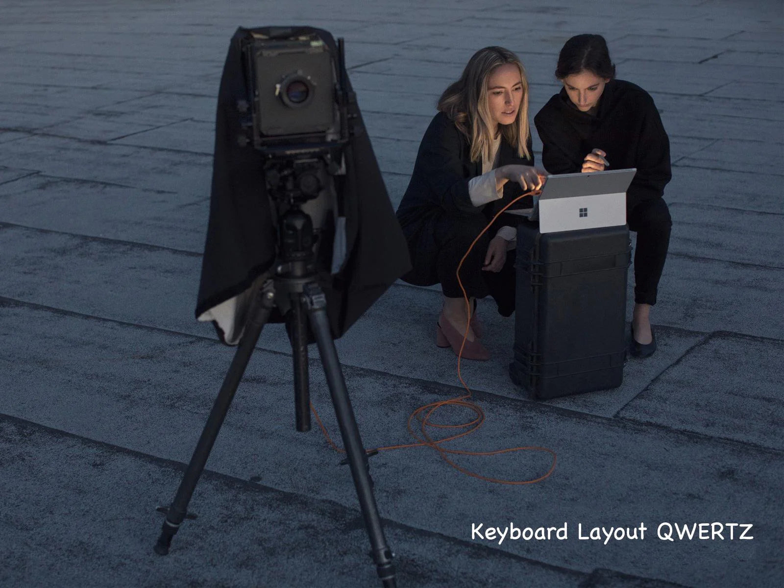 Life image of to females working on notebook microsoft surface pro connected to the camera