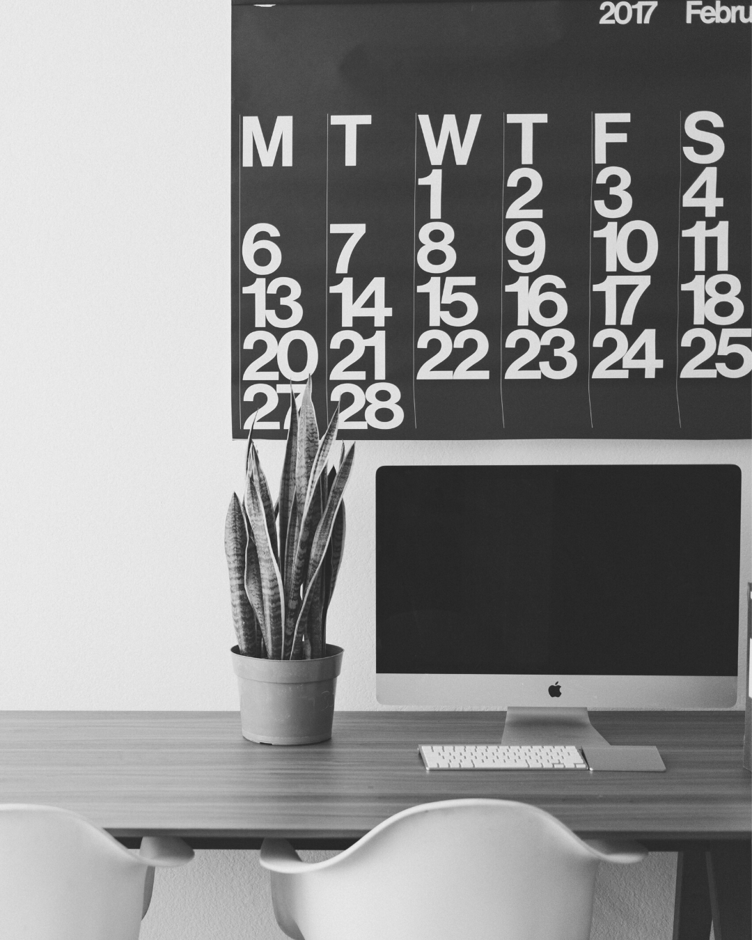 Office with calendar and a computer on the desk