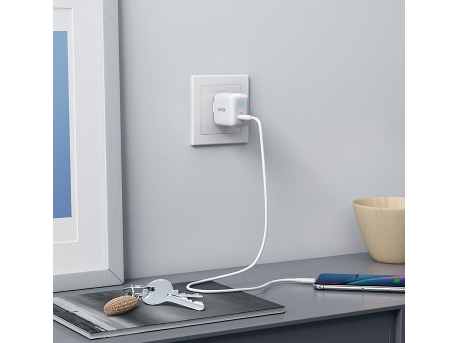 Image shows the Anker PowerPort PD USB-C 18W Fast Charger White plugged in
